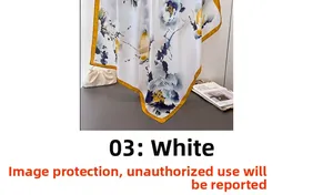 Detail of white silk scarf with ink blue and ginger floral patterns and yellow borders