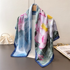 Elegant ink-wash floral silk scarf with lotus pattern hanging on a wooden hanger