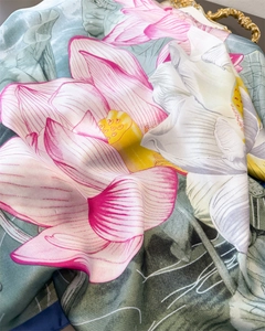 Close-up of silk scarf with lotus ink painting texture and smooth fabric drapes