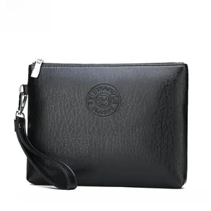 Macro detail of black litchi grain PU leather texture and silver zipper on men's clutch bag
