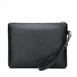 Close-up of black litchi texture PU leather clutch with silver metal zipper detail