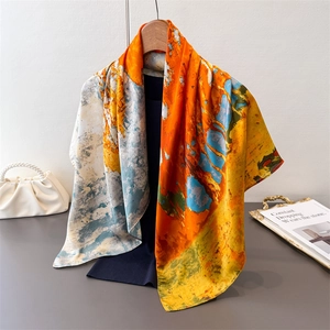 Detail of artistic abstract oil painting silk scarf draped over a wooden hanger