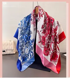 Detailed shot of large printed silk scarf with floral pattern hanging on wooden hanger