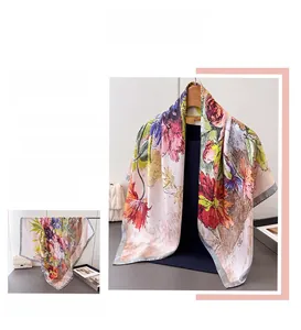 Macro view of silky floral square scarf featuring vintage red peony prints on beige fabric