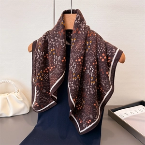 Brown herringbone cotton linen feel square scarf with floral pattern on wooden hanger