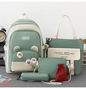 Detail view of five-piece Morandi green and beige student backpack set with badges
