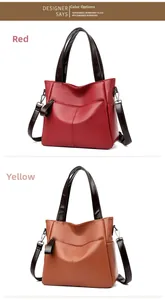 Detail view of large tote bags in burgundy and yellow with lychee grain leather texture