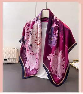 Close-up of elegant floral print silk scarf with deep purple peonies and blue borders