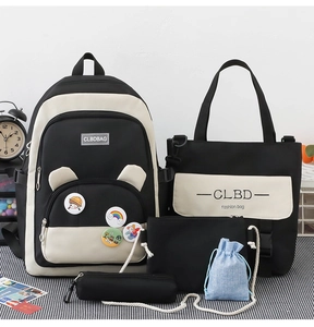 Detail of five-piece black and white school backpack set with matching accessory bags