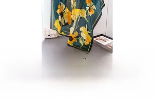 Detail of silk-feel floral scarf with yellow sunflower prints on dark green fabric