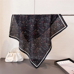 Poetic herringbone cotton-linen silk scarf with floral pattern hanging on a metal rack