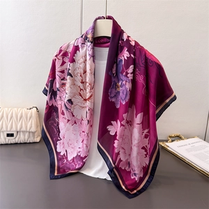 Close-up of elegant purple peony print on glossy satin silk large square scarf fabric