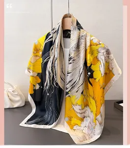 Detail of silk-like scarf featuring artistic goldfish and floral prints in yellow and black