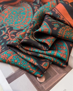 Detailed close-up showing the soft silk texture and intricate paisley floral patterns