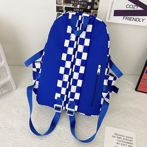 Blue and white checkerboard canvas backpack with adjustable straps and side pockets