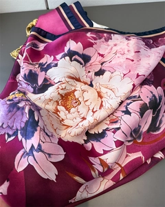 Detail of silk-like satin scarf featuring realistic peony print and elegant navy border