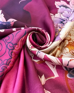 Macro detail of silk scarf showing smooth texture with peony and cloud print patterns