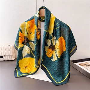 Artistic marble pattern silk scarf with yellow floral prints draped on a hanger