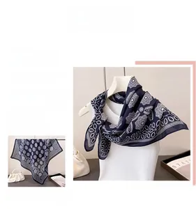 Detail view of navy blue chiffon scarf with white floral and geometric vintage patterns
