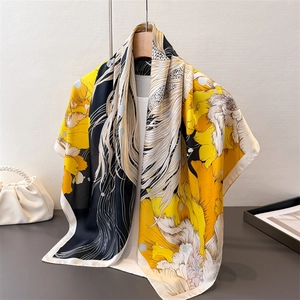 Silk-like floral scarf with goldfish patterns hanging on a hanger for women