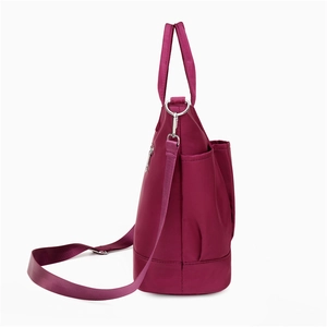 Lightweight magenta nylon shoulder bag with silver zippers and large capacity