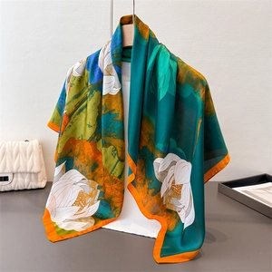 Elegant dark green silk scarf with white lotus floral print and orange border detail