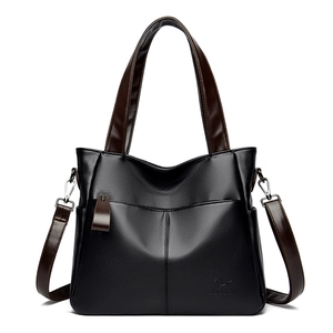 Large black pebbled leather tote bag with brown straps and adjustable shoulder strap