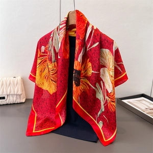 Detailed macro view of goldfish floral silk square scarf with vibrant red and orange petals