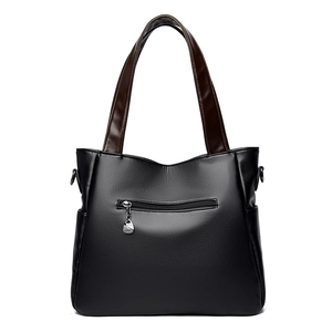 Black pebbled leather tote bag with brown contrast handles and front zipper pocket