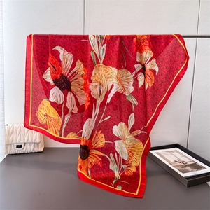 Elegant red silk square scarf with white lily floral print and smooth draped texture