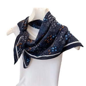 Navy blue herringbone silk-feel scarf with orange floral prints on a white mannequin