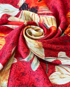 Macro detail of the elegant floral silk scarf with soft rose fold and glossy texture