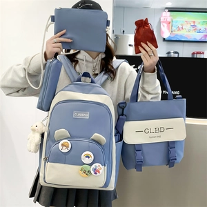 Blue and white four-piece school backpack set with canvas tote and cute accessories
