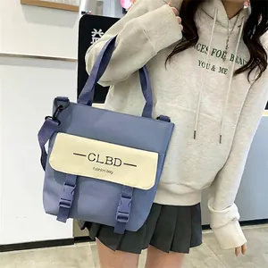 Casual blue and beige canvas tote bag with adjustable straps and buckles for students