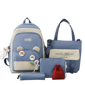 Five-piece blue and beige school backpack set with cute pins and matching accessories