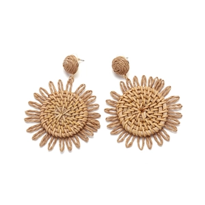 Detail view of Bohemian handmade raffia sunflower earrings with woven spiral texture