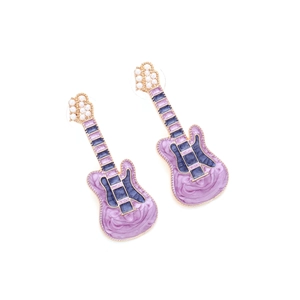 Detailed macro view of purple marble enamel guitar earrings with white faux pearls