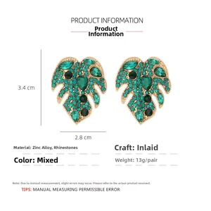 Detailed view of monstera leaf earrings with green rhinestones and 3.4cm x 2.8cm dimensions