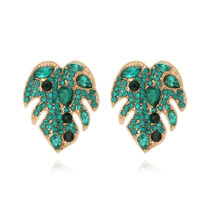 Tropical monstera leaf earrings with green crystals and pearls on a white background