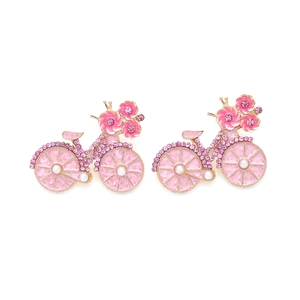 Detail of pink enamel bicycle earrings with sparkling crystals and pearl accents