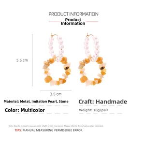 Detailed view of bohemian double-circle earrings with faux pearls and natural stones