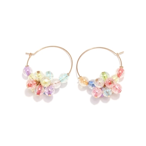 Detailed view of large gold hoop earrings with multi-color cracked glass beads decoration