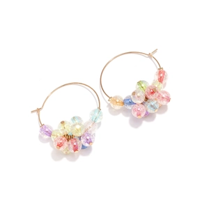 Detailed close-up of colorful crackle glass beads on golden hoop earrings for women