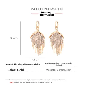Detailed view of gold long tassel earrings with sparkling rhinestones, 9.5cm length drop