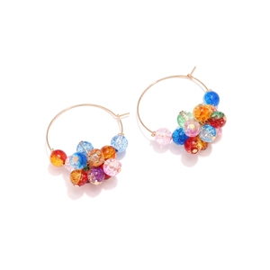 Detail of gold hoop earrings featuring multi-colored crackle beads with vibrant reflections