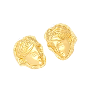 Detailed view of vintage gold relief portrait earrings with classic laurel leaf accents