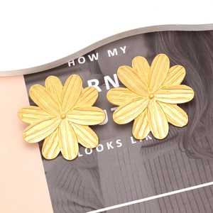 Minimalist gold floral stud earrings with multi-layered petals and textured finish