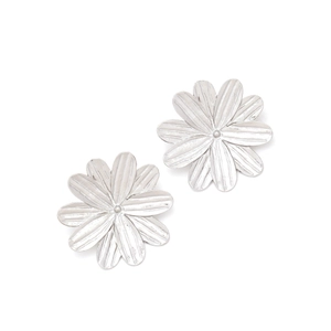 Macro detail of silver blooming flower earrings with textured petals and metallic finish
