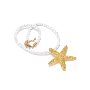 Detailed view of a gold starfish pendant necklace with white twisted rope and metal clasp