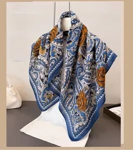 Detailed paisley and floral patterns on elegant navy blue and orange women's scarf